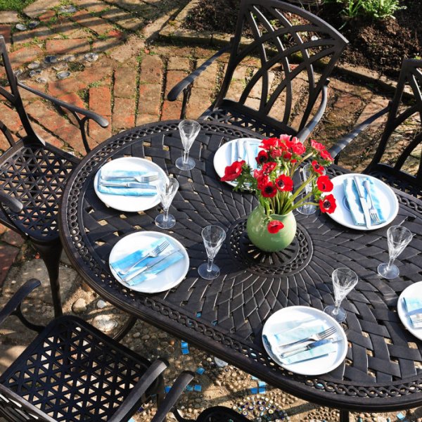Close up the June 6 seater garden table and April chairs in antique bronze
